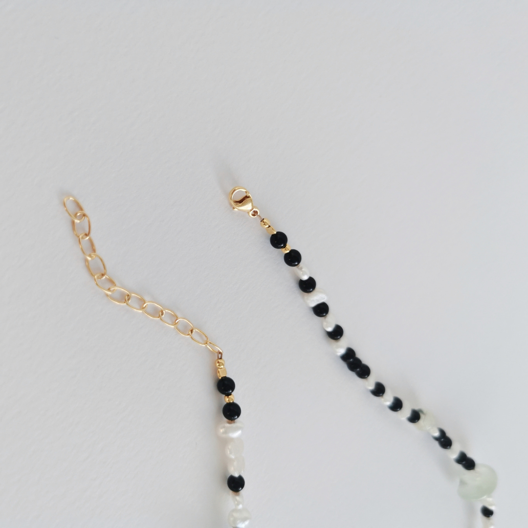 Asymmetrical Semiprecious Gemstone Bead Necklace with Green Prehnite, Black Onyx, White Freshwater Pearls, Gold Vermeil Hardware and Extension Chain, Closeup of Clasp and Extension Chain on a White Background