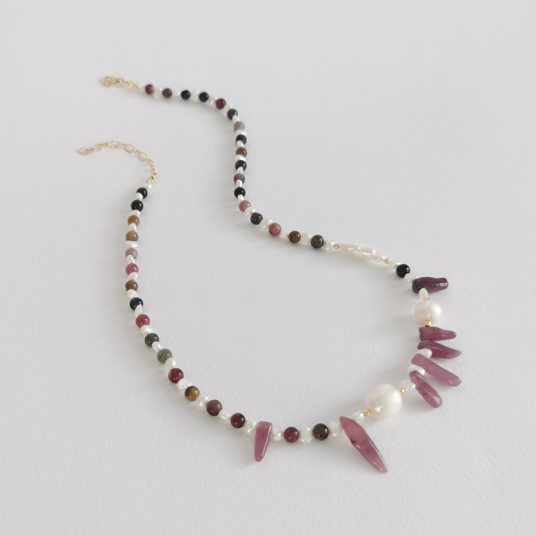 Asymmetrical Semiprecious Gemstone Bead Necklace with Pink Ruby, Multicoloured Tourmaline, Black Tourmaline, Pink Tourmaline, White Freshwater Pearls, Gold Vermeil Hardware and Extension Chain, on a White Background