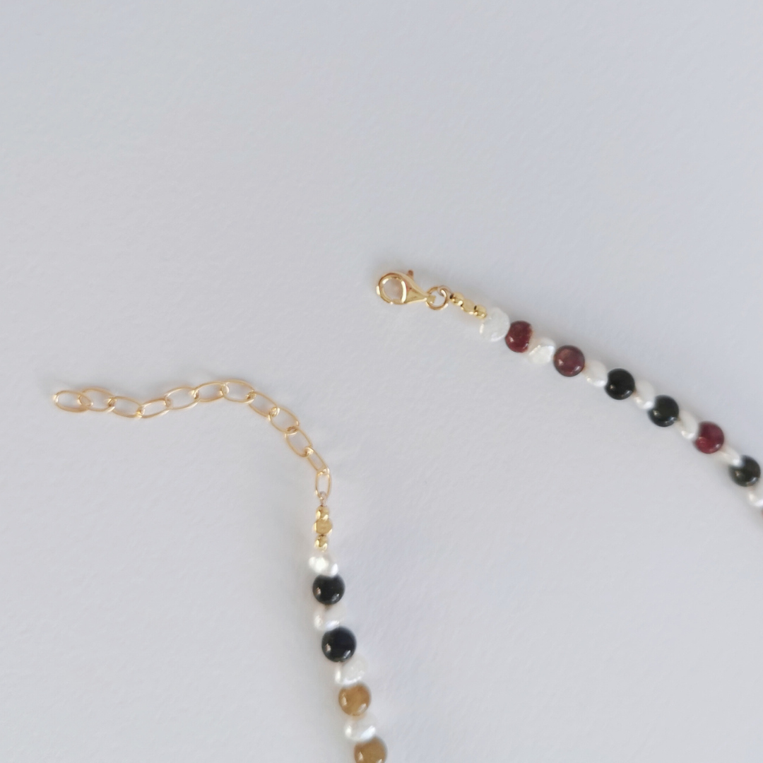 Asymmetrical Semiprecious Gemstone Bead Necklace with Pink Ruby, Multicoloured Tourmaline, Black Tourmaline, Pink Tourmaline, White Freshwater Pearls, Gold Vermeil Hardware and Extension Chain, Closeup of Clasp and Extension Chain on a White Background