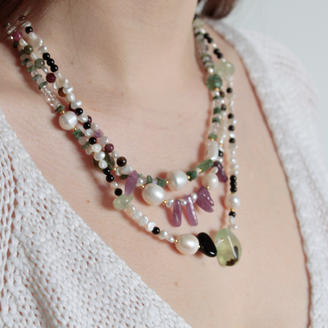 Three Layered Semiprecious Gemstone Bead Necklaces on a Model, with Green Emerald, Green Tourmaline, Clear Quartz, White Rainbow Moonstone, White Freshwater Pearl, Pink Ruby, Multicoloured Tourmaline, Prehnite, Black Onyx and all Gold Vermeil Hardware
