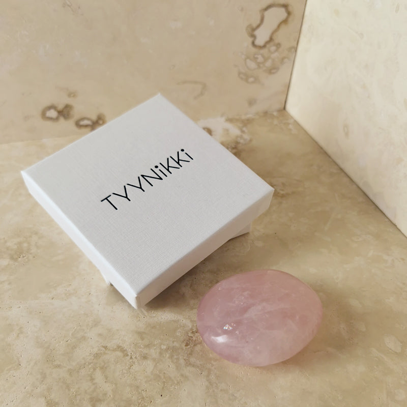 high quality rounded blush pink polished Rose Quartz palm crystal with packaging, a slick white cardboard box